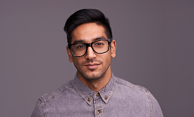 Image showing Young man, portrait and glasses in studio for eye care, vision and new frame with confidence on a gray background. Happy face of a young person or model in spectacles, eyewear and vision with lens