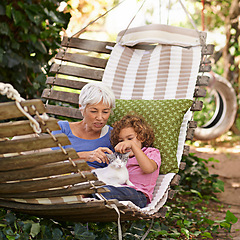 Image showing Backyard, grandmother and boy with cat, relax and sunshine with weekend break and vacation. Family, old woman and grandchild with pet and hammock in a backyard with animal, bonding together in spring