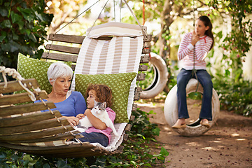 Image showing Grandmother, cat and children in a backyard, relax and bonding together with weekend break and happiness. Family, granny and grandkids with pet and playing with nature and outdoor for fresh air