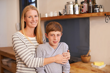 Image showing Mother, son and hug in portrait with smile, happiness and comfort for security with woman and boy relax in kitchen. Family, trust and affection with bonding, childhood with single parent at home