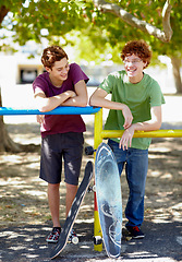 Image showing Teenager boy, friends and happy with skateboard in park for summer, vacation and relax by trees. Gen z people, skater and smile at playground for outdoor sport with social conversation in Vancouver