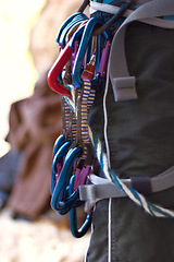 Image showing Carabiners, rock climbing gear and harness for safety in adventure sport equipment and exercise in mountain. Fitness, activity or steel rope for grip or anchor point connection for secure attachment