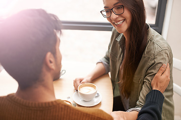 Image showing Couple, date and coffee shop with conversation, love and talking together with hot drink in a cafe. Woman, smile and happy from discussion and chat in a restaurant with tea or cappuccino at a table