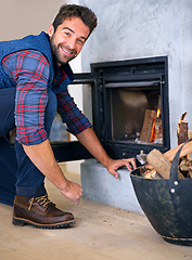 Image showing Fireplace, fire and portrait of man in home for heat, warmth and light in winter with wood. Flame, burning and person with firewood or log for comfortable, cozy and relaxing house in living room