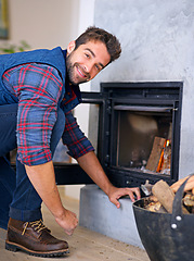 Image showing Fireplace, wood and portrait of man with fire for heat, warmth and light in winter in home. Flame, burning and person with firewood or logs for comfortable, cozy and relaxing house in living room