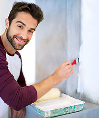 Image showing Painting, wall and portrait of man in home for renovation, remodeling and maintenance. Interior design, construction and person with paintbrush, roller and paint equipment for DIY project in house