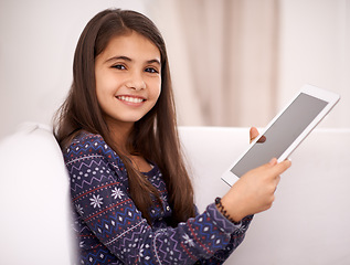 Image showing Portrait, smile or child with tablet for streaming, playing games or watching fun videos on movie website. Relax, house or happy kid with technology to download on social media app on screen on sofa