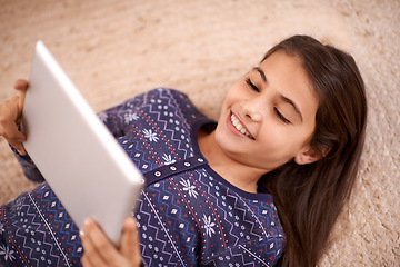 Image showing Floor, smile or child with tablet for streaming, playing games or watching fun videos on movie website. Above, house or happy kid with technology to download online or fun social media app to relax