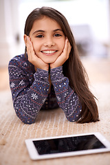 Image showing Floor, portrait or kid with tablet for streaming, playing games or watching fun videos on movie website. Girl, house or happy child with technology to download online or social media app to relax