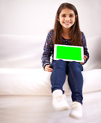 Image showing Portrait, green screen or child with tablet for mockup, playing games or streaming videos on movie website. Space, house or happy kid with smile or technology to download on social media app on sofa