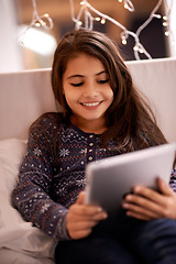 Image showing Girl, kid and tablet, technology and communication with ebook for reading and social media at home. Elearning, movie or storytelling app with internet, browsing and digital platform for gaming