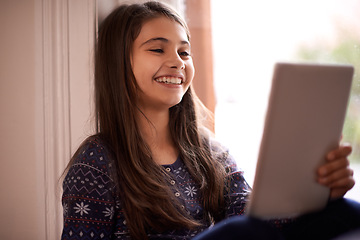 Image showing Girl, kid and tablet, happy with technology and relax with ebook for reading and social media at home. Elearning, cartoon or storytelling app with internet, browsing and digital platform for gaming