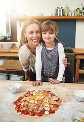 Image showing Woman, girl child and cooking pizza with smile in portrait with hug in kitchen for learning, help and development. Food, mother and daughter with dough, teaching and happy for bonding in family home