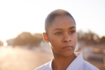 Image showing Serious woman, face and thinking with karate Gi, self defense training or vision for outdoor martial arts. Determined female person, trainer or tough fighter in fitness, protection or fighting skills