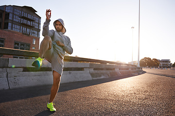 Image showing Serious man, muay thai and fitness with knee in city for self defense, fighting technique or style. Male person, fighter or athlete in Ki training, martial arts or stance on street or road in town