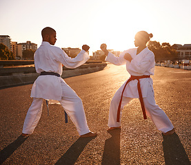 Image showing People, karate and fighting with personal trainer for self defense, technique or style in city street. Man and woman fighter or athlete in fitness training, martial arts or kick boxing in urban town