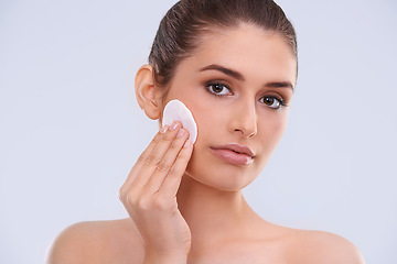 Image showing Portrait, woman and cotton pad for makeup removal from skin, cosmetics and beauty product on white background. Skincare routine, cleanse and wipe face, dermatology and facial treatment in studio