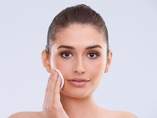 Image showing Portrait, woman and cotton pad for cleaning makeup from skin, cosmetics and beauty product on white background. Skincare routine, cleanse and wipe face, dermatology and facial treatment in studio