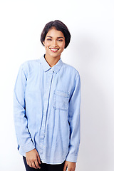 Image showing Indian woman, fashion and happy in studio for portrait with denim shirt for trendy outfit by white background. Isolated girl, person and model with smile for casual style in edgy clothes in Mumbai