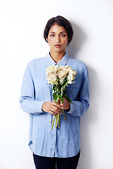 Image showing Flowers, bouquet and portrait of indian woman in studio, romantic and floral gift for valentines day. Person, face and serious with roses as present of love, plants and florist by white background