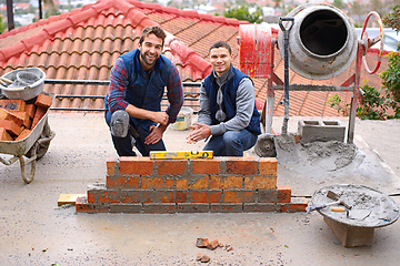 Image showing Construction, bricklayer and men building a brick wall, handyman or contractor with trade, mentor and apprentice in industry. Team, builder and cement with tools, maintenance renovation for training