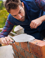 Image showing Construction worker, bricklayer and man building a brick wall, handyman or contractor with trade in industry. Plastering, builder and cement with tools, maintenance and renovation for architecture