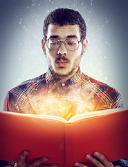 Image showing Thinking, glowing book and man with story, fantasy and education on grey studio background. Person, model and guy with novel and literature with knowledge and learning with light, creative or magic