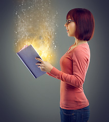 Image showing Profile, glowing book and woman with magic, story and education on grey studio background. Person, model and girl with novel and literature with knowledge and learning with light, creative or fantasy