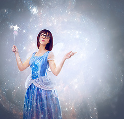 Image showing Studio, princess and woman with wand for magic, happiness and looking for wishes for fantasy in background. Adult, female person and girl with butterfly wings, dress and model with joy and mystical