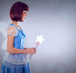 Image showing Whimsical, fairy and woman with wand of magic and lighting for fantasy in grey background. Adult, female person and girl with butterfly wings, dress and model with joy and mystical in studio