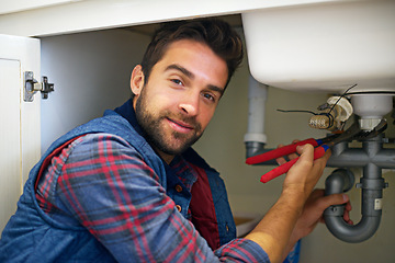 Image showing Man, portrait and plumber with wrench for pipe repair, service or fix in home maintenance or indoor leak. Male person or handyman smile with water damage or sink of plumbing professional at the house