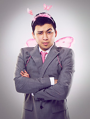 Image showing Studio, portrait and man as fairy for magic in Halloween party of startup up business and company. Adult, guy and male person with professional suit, costume and frown on face with arms crossed