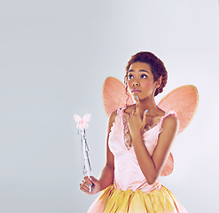 Image showing Woman, fairy and costume for fantasy in studio with wand, thinking and mockup space by white background. Person, dancer or girl with magic, ideas and butterfly wings for ballet, art and creativity