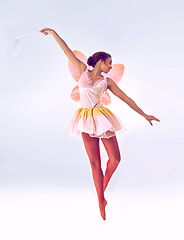 Image showing Woman, fairy and ballerina for dancing in studio for fantasy, flight and moving by white background. Person, dancer and girl with magic, costume and butterfly wings for ballet, art and creativity