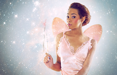 Image showing Woman, fairy and magic with glitter in studio portrait for wand, shine and pride with stars on background. Person, model or girl for fantasy, costume and butterfly wings for story, art and creativity