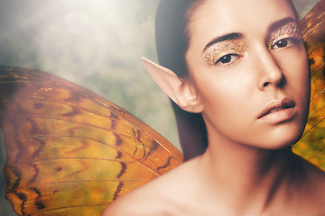 Image showing Fairy, woman and wings in nature with makeup, portrait or glow for fantasy, dream or surreal story. Girl, magic and beauty with butterfly with creativity, art and glitter for cosmetics with mythology