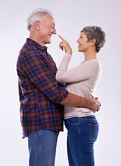Image showing Senior, couple and happy hug in studio together, smile and retired people in elderly love relationship. Pointing, female person with man on white background, affection on mockup space with joy