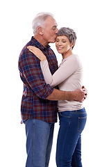 Image showing Kiss, hug and senior couple on a white background for bonding, affection and loving relationship. Marriage, happy and mature man and woman embrace for commitment, love and care in studio together