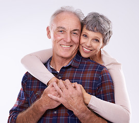 Image showing Love, hug and portrait of senior couple on a white background for bonding, affection and loving relationship. Marriage, happy and mature man and woman embrace for commitment, trust and care in studio