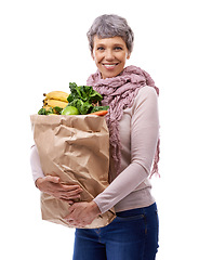 Image showing Woman, paper bag and portrait with vegetables for shopping, groceries and consumer for nutrition and fruits in studio. Mature lady, happy and hold produce for health and food on white backdrop