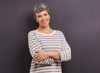 Image showing Portrait, smile and senior woman with arms crossed, retirement and happiness on a grey studio background. Face, elderly person and mockup space with old lady and pensioner with joy, calm and cheerful