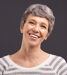 Image showing Portrait, happiness and elderly woman with retirement, joyful and casual outfit on a grey studio background. Face, pensioner and old person with mockup space and cheerful with trendy clothes or smile