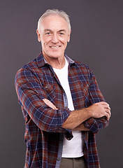 Image showing Senior, fashion and man in portrait with crossed arms, confidence or modern style on grey background. Proud person, casual model and happy mature guy in studio with smile, clothes or pride in England