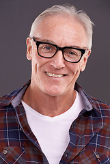 Image showing Mature man, fashion and glasses with smile in studio on background for eyewear, optometry and satisfied. Portrait, happy and style or casual outfit with positivity for retirement and enjoy with laugh