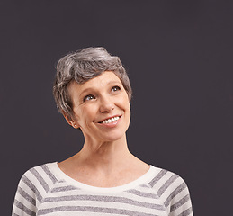 Image showing Happy, thinking and senior woman in studio for faq, brainstorming or problem solving on black background. Questions, planning and old lady model curious about announcement, information or deal offer