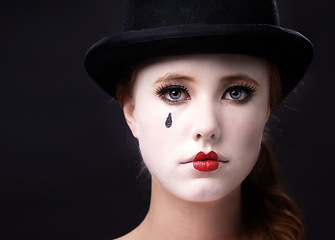 Image showing Portrait, woman and circus performer in studio on white background with creative makeup for entertainment, artist and mime. Face, female person and career with hat for performance or rehearsal