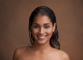 Image showing Hair, wet or portrait of happy woman in studio for beauty, wellness or shine cosmetics on brown background. Haircare, cleaning or face of Indian female model smile for shampoo, results or scalp detox