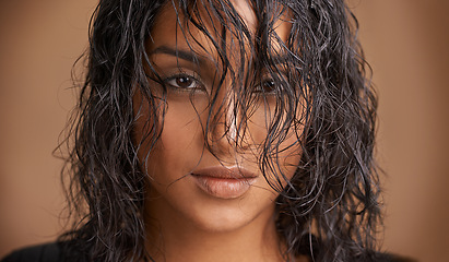 Image showing Wet hair, portrait and Indian woman in studio for beauty, wellness or shine cosmetics on brown background. Haircare, cleaning or calm female model face with shampoo, results or scalp detox treatment