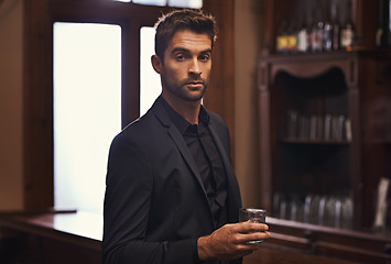 Image showing Businessman, confident portrait or alcohol on break in hotel or drink to relax on corporate trip. Entrepreneur, pub or serious face by glass of whisky for leisure or young professional on work travel