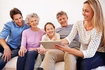 Image showing Generations, tablet and family with smile, home and relax on sofa of living room for bonding. Grandparents, father and mother with technology for girl, growth and development of child with internet